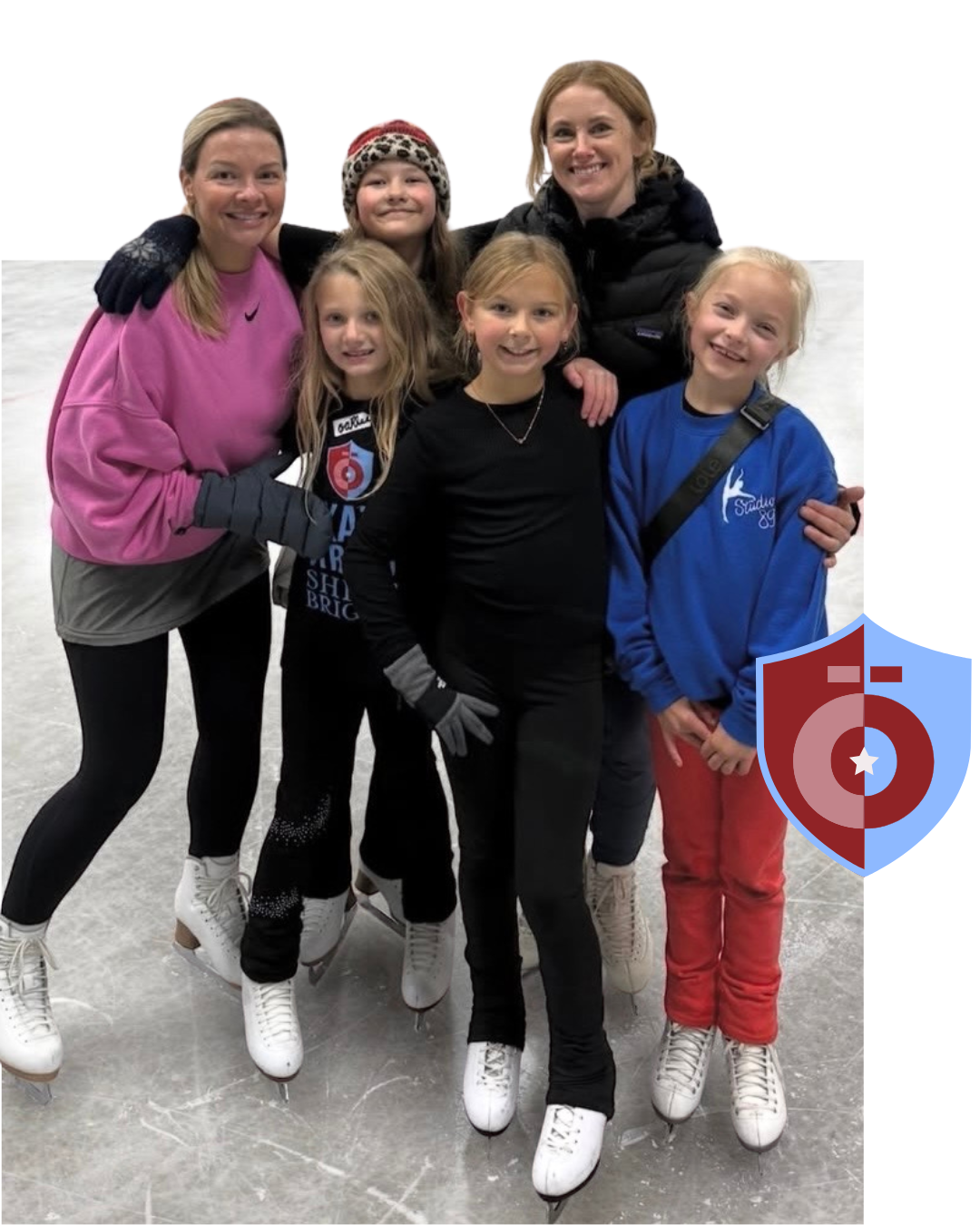 Group of people smiling on an ice rink, some with ice skates on, near a shield graphic.