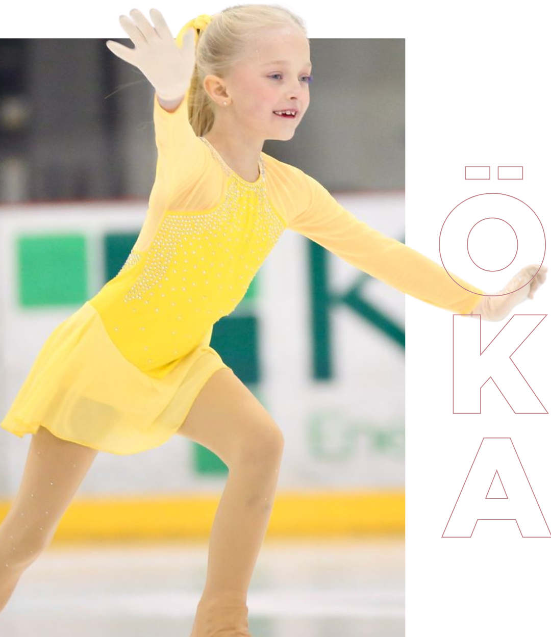 Young skater in yellow dress on the ice, arm extended, smiling.