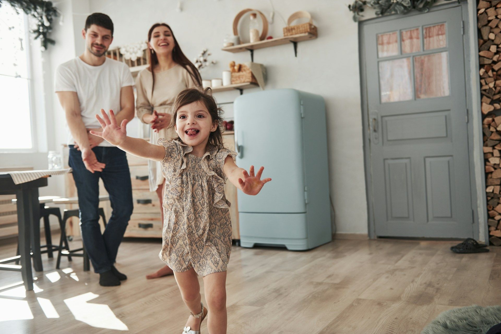 An elderly couple examines paperwork together at a table, one pointing while the other types on a laptop.