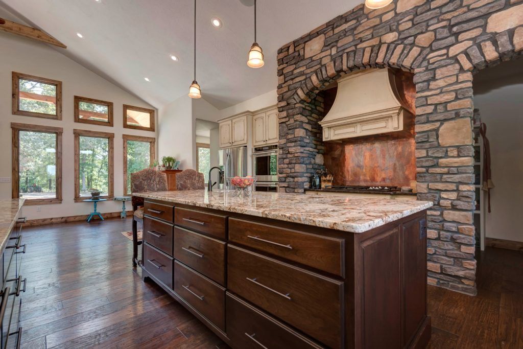 Kitchen With A Large Island And A Stone Wall — Willard, MO — Bill’s Custom Woodworks
