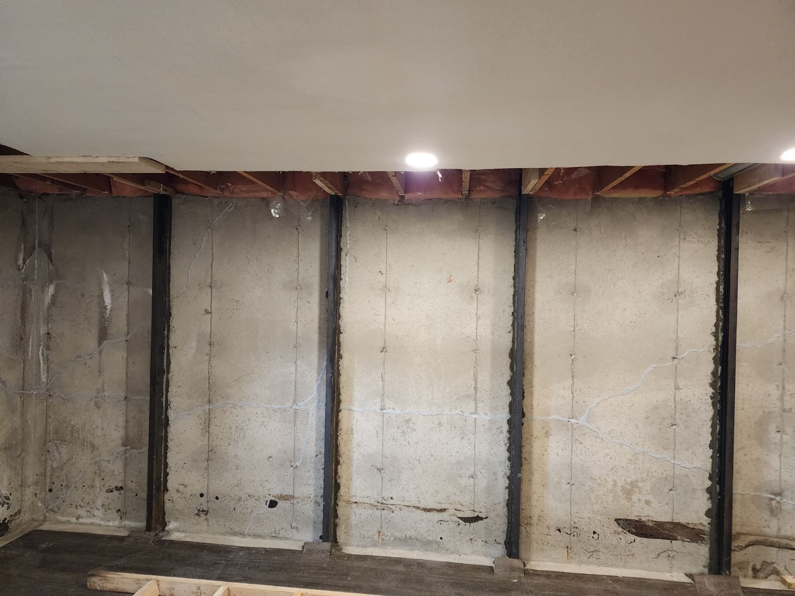 Concrete basement wall with steel supports,