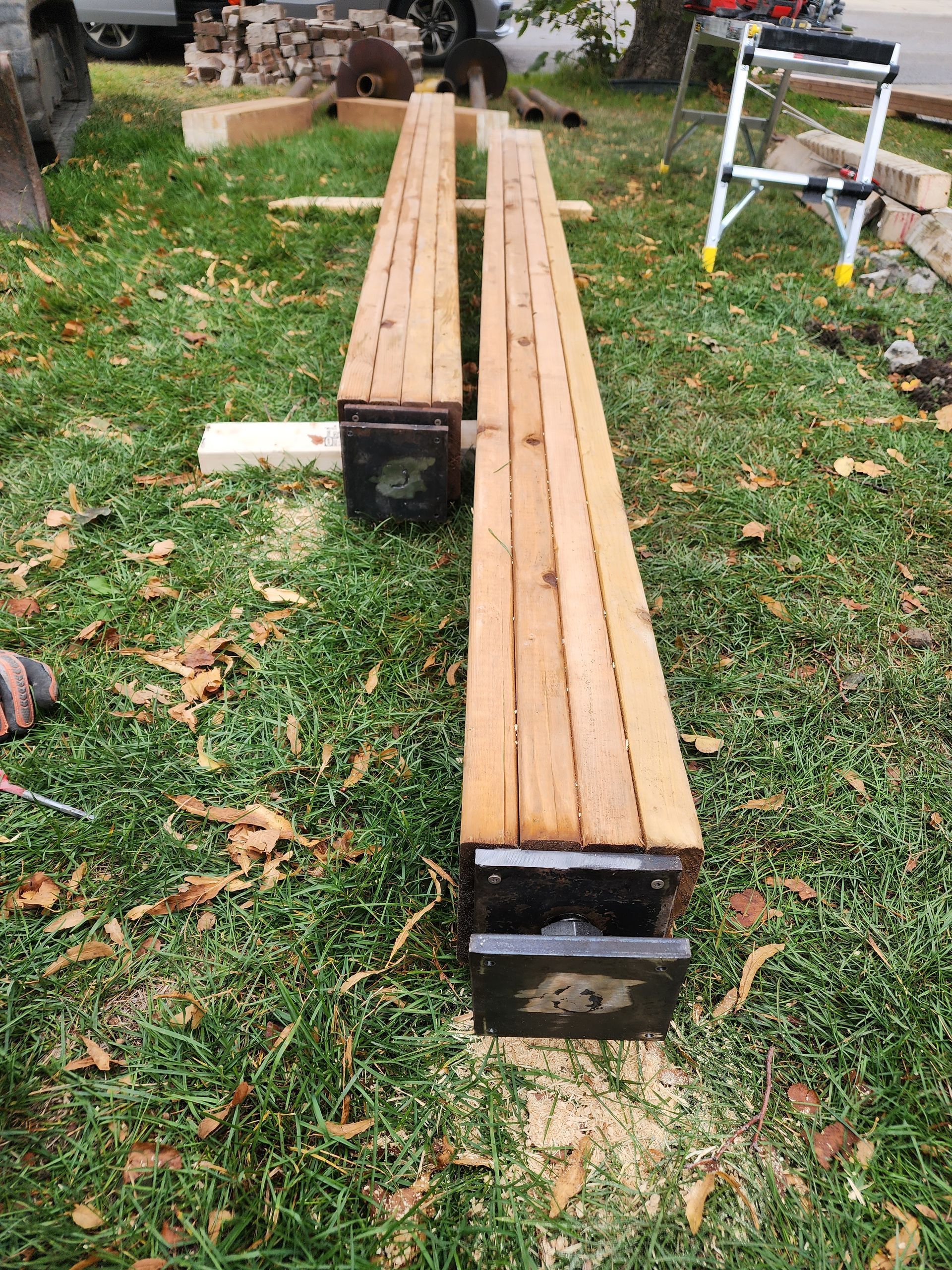 Two wooden beams with metal bases