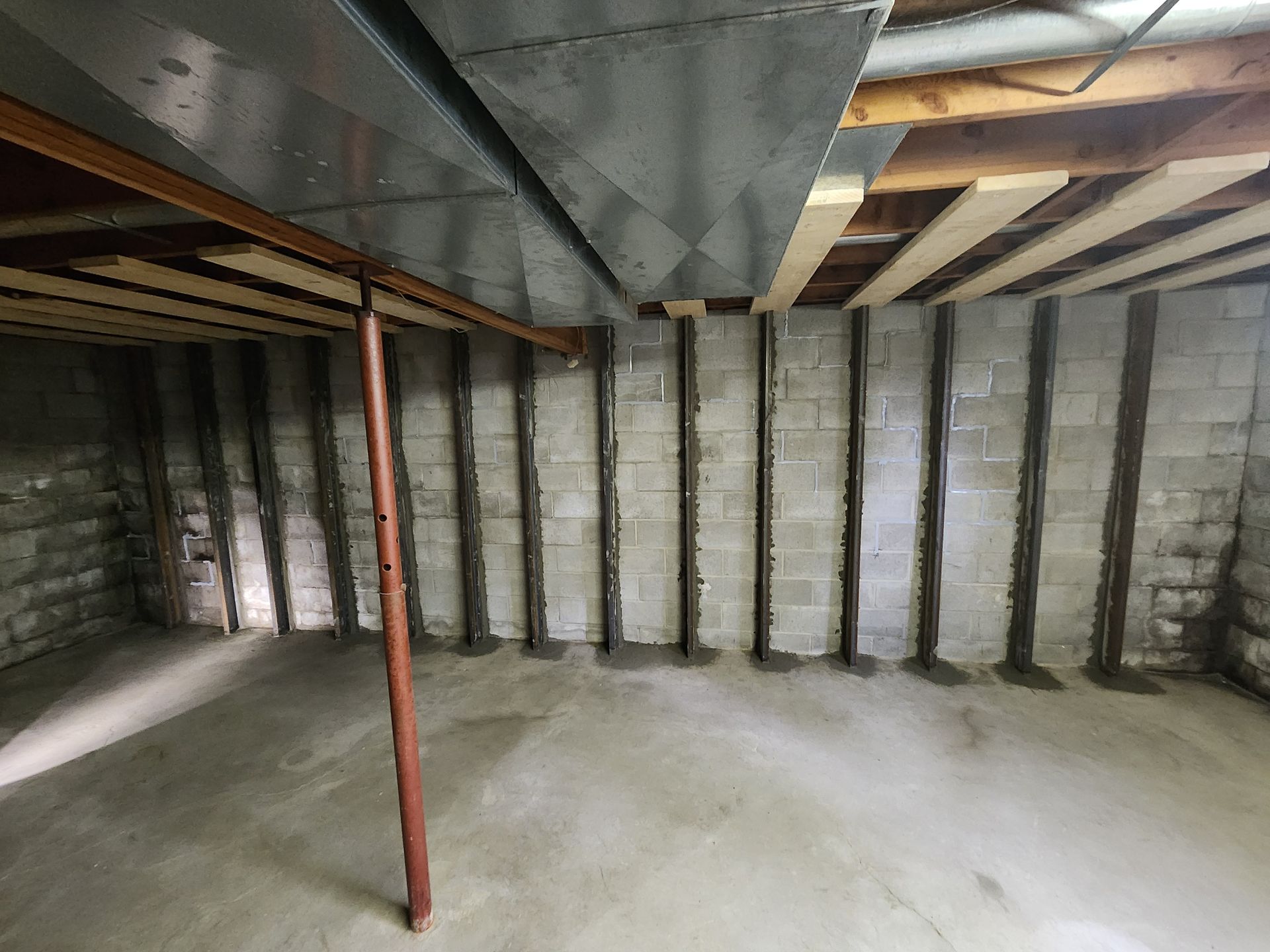 Basement with concrete floor, block walls, support beams