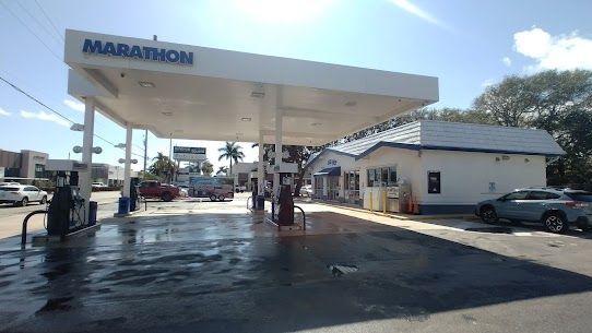 A marathon gas station with cars parked in front of it