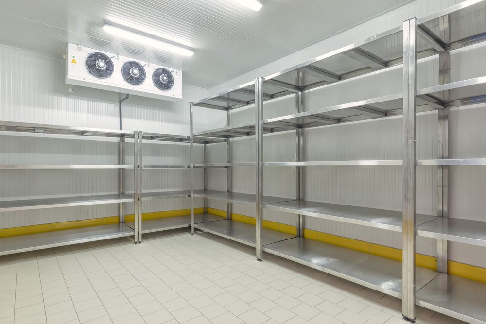 Empty Stainless Steel Shelves Inside a Commercial Walk-In Refrigerator — Gilmour Air & Electrical in Coonamble, NSW