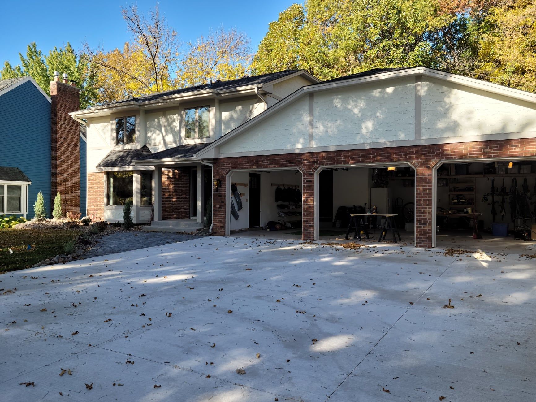 A large house with a garage and a driveway in front of it.