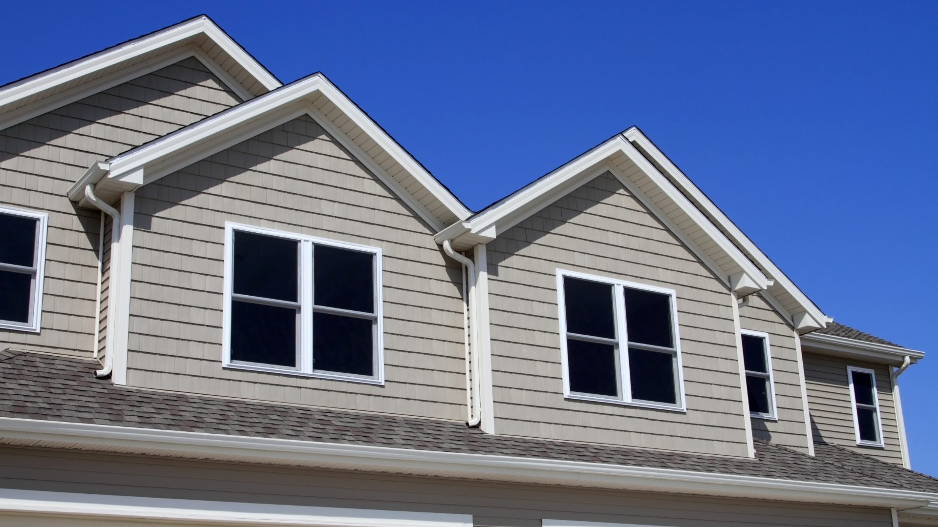 The roof of a house with a blue sky in the background