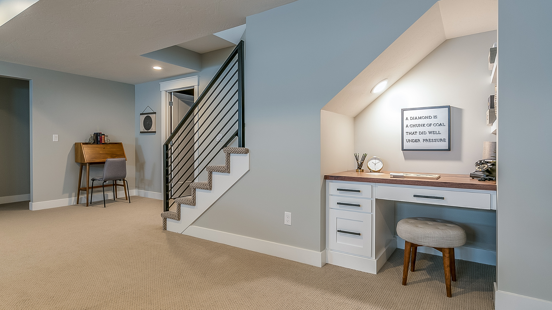 There is a desk under the stairs in the basement.