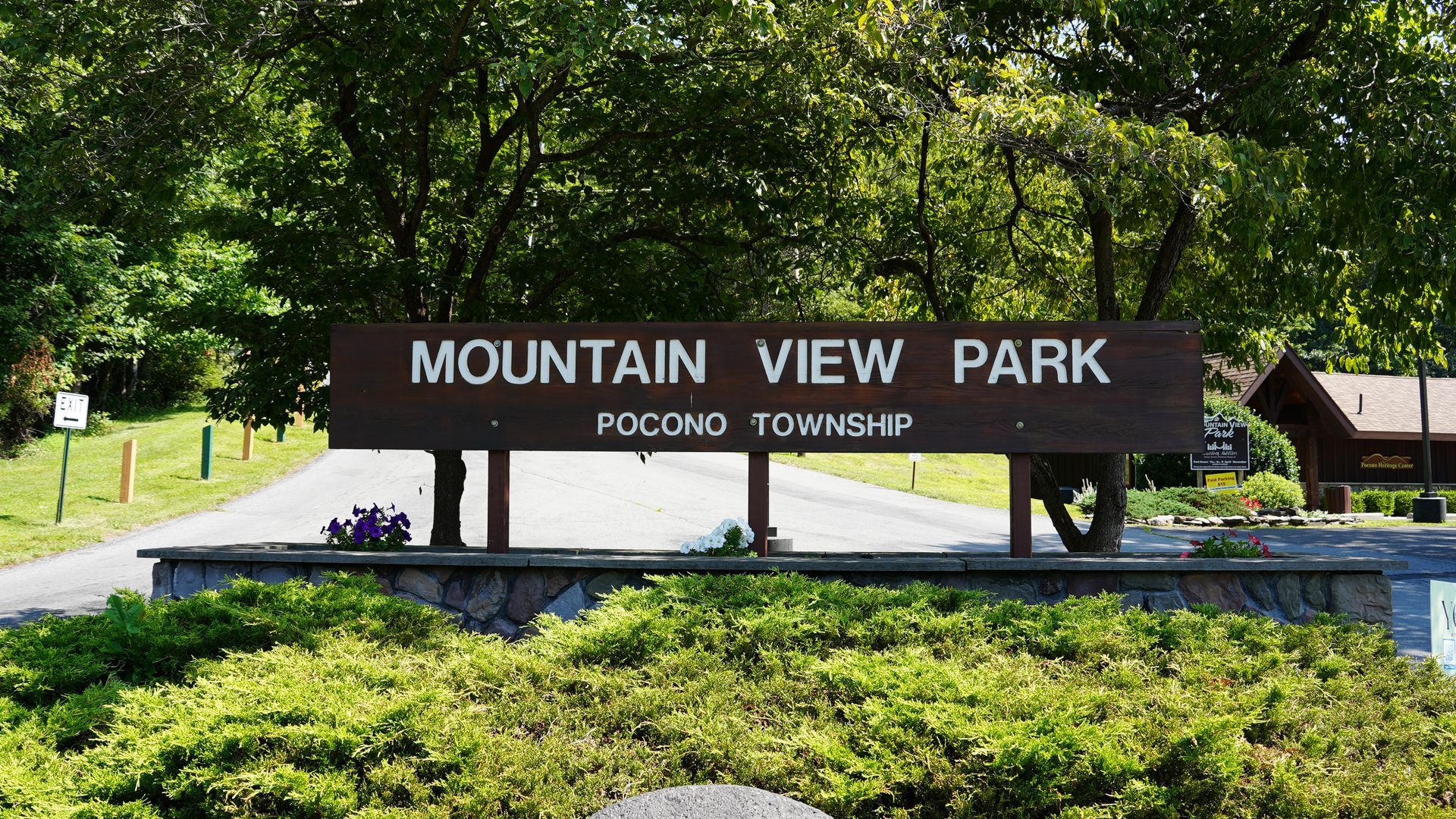Sign for Mountain View Park in Pocono Township, with trees and greenery around it.