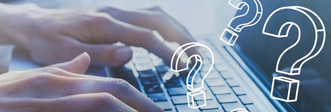 Hands typing on a laptop keyboard with overlaid question marks.