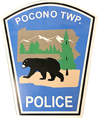 Pocono Township Police badge: bear silhouette, mountains, pine tree, Pennsylvania outline, blue and white.