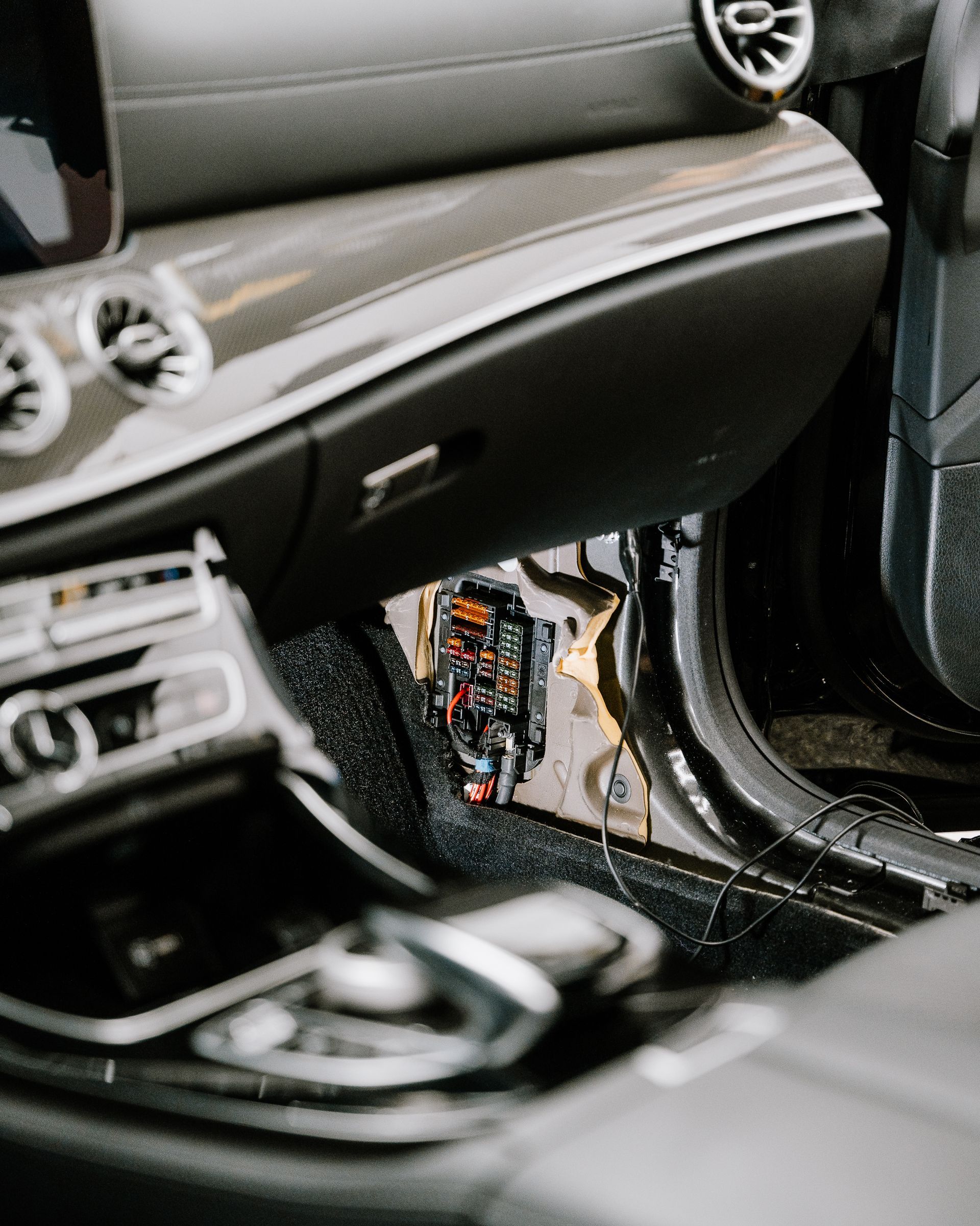 A close up of the interior of a car with water coming out of the door.