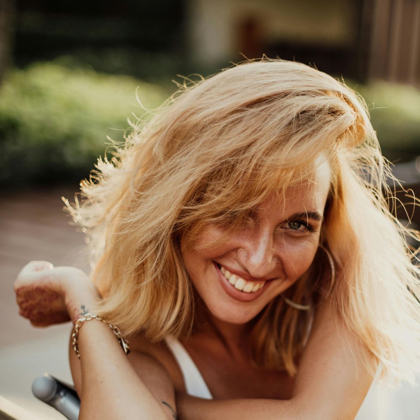 A woman with blonde hair is smiling for the camera