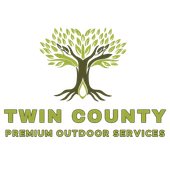 Logo for Twin County Premium Outdoor Services featuring a stylized green tree with hands reaching upward in its canopy.