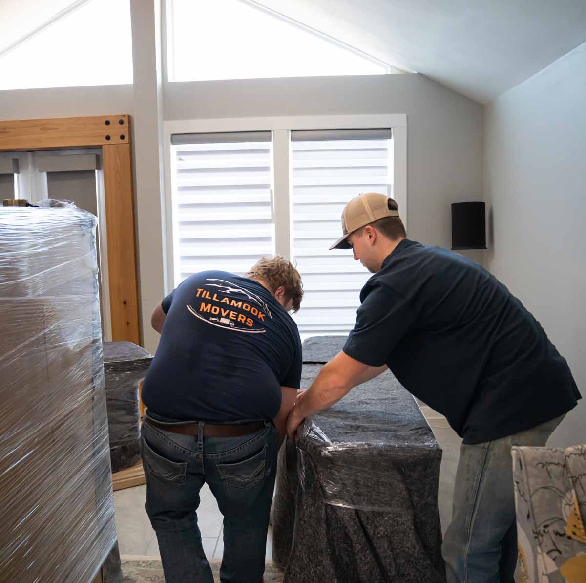 A man wearing a blue shirt that says ' oklahoma moving ' on it