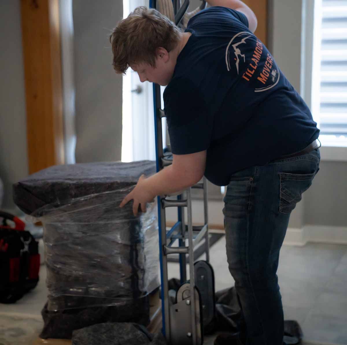 A man wearing a shirt that says ' i 'll always move you ' on it