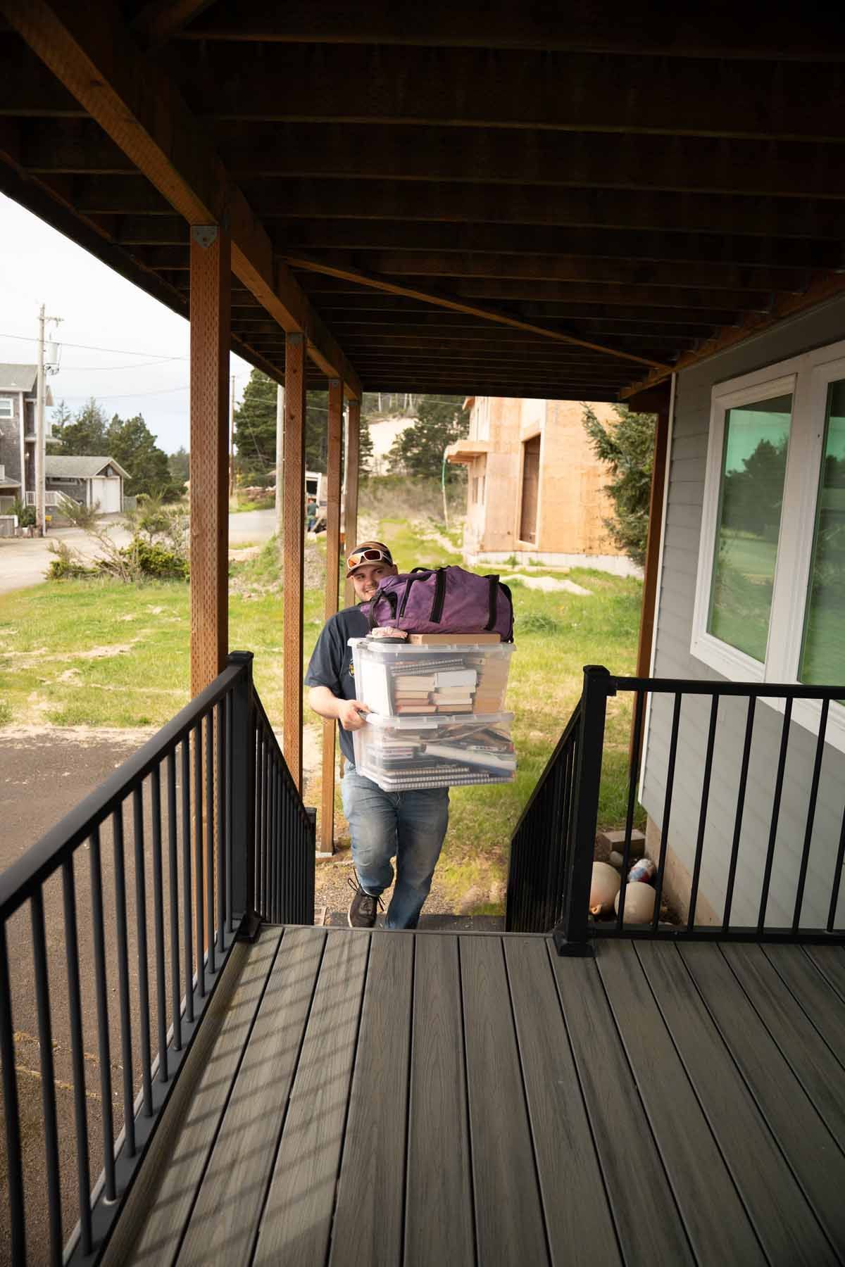 A man is carrying a box up a set of stairs.