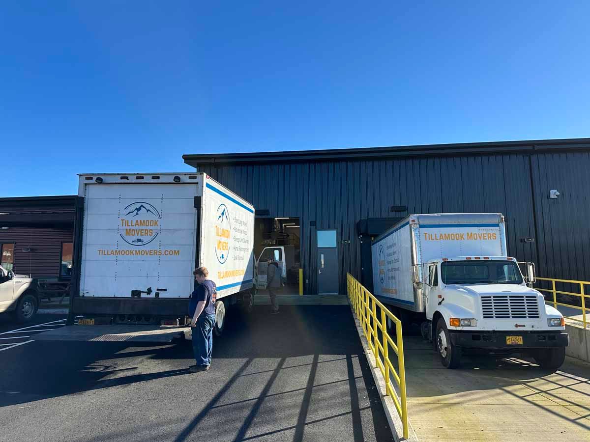 Two trucks are parked in front of a building.