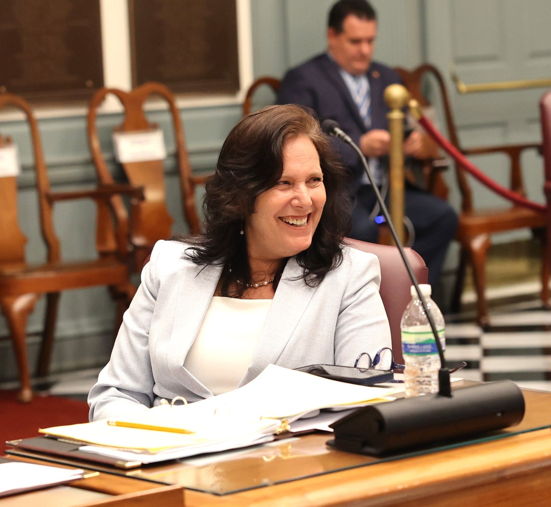 Senator Hoffner smiling while seated in legislative hall