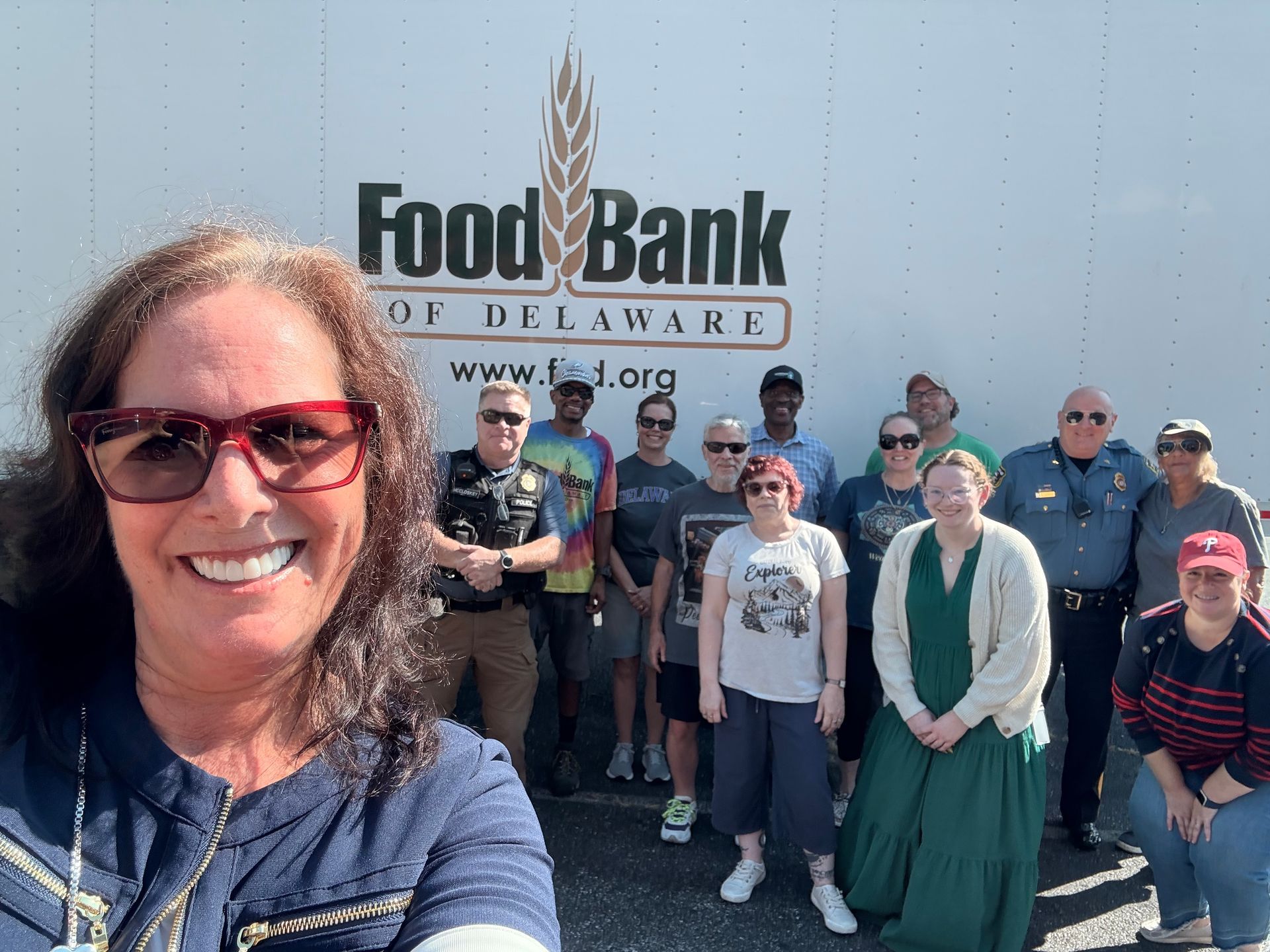 Senator Hoffner outside with volunteers in front of a Food Bank of Delaware truck