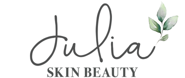 A logo for julia skin beauty with leaves on a white background.