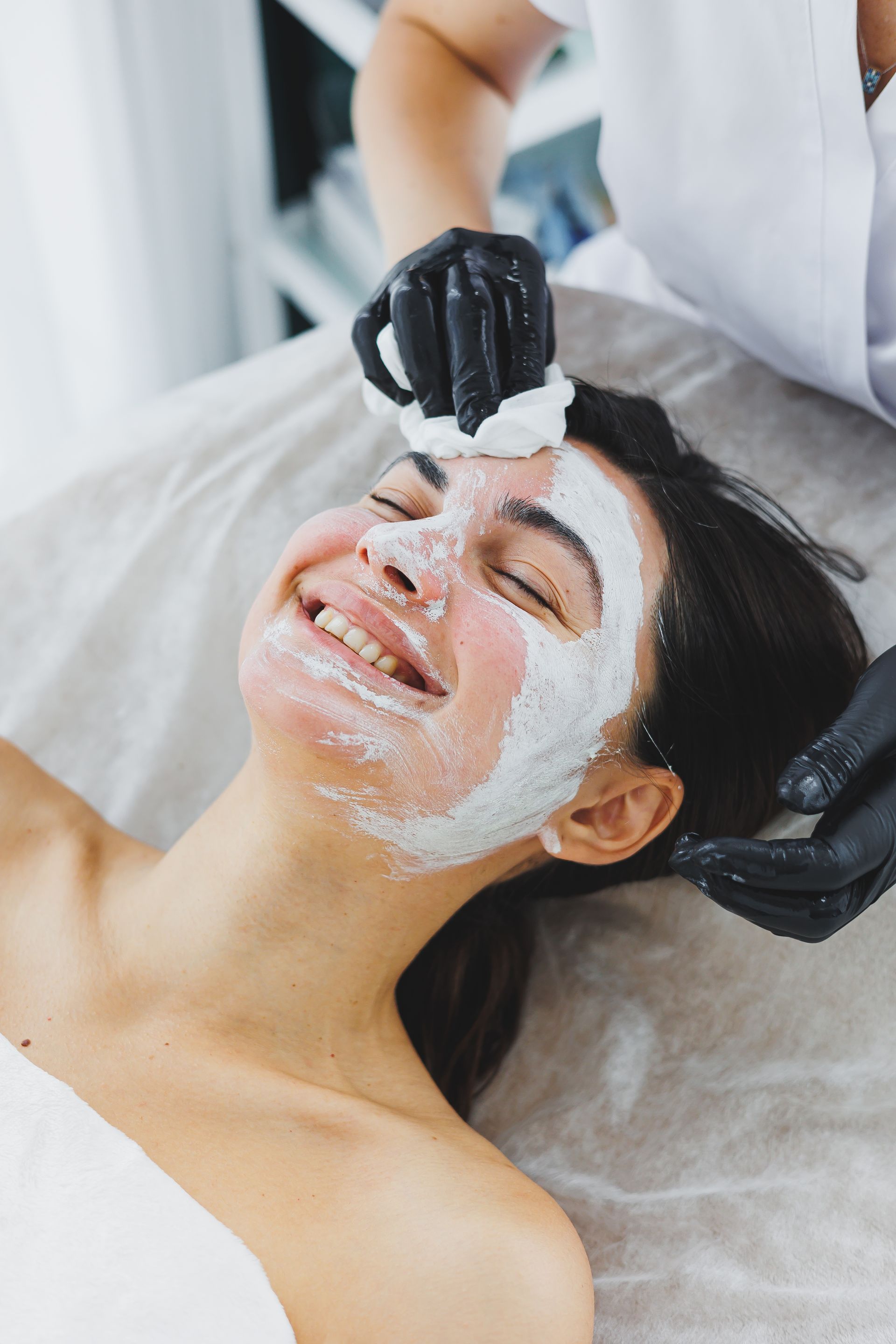 A woman is getting a facial treatment at a spa.