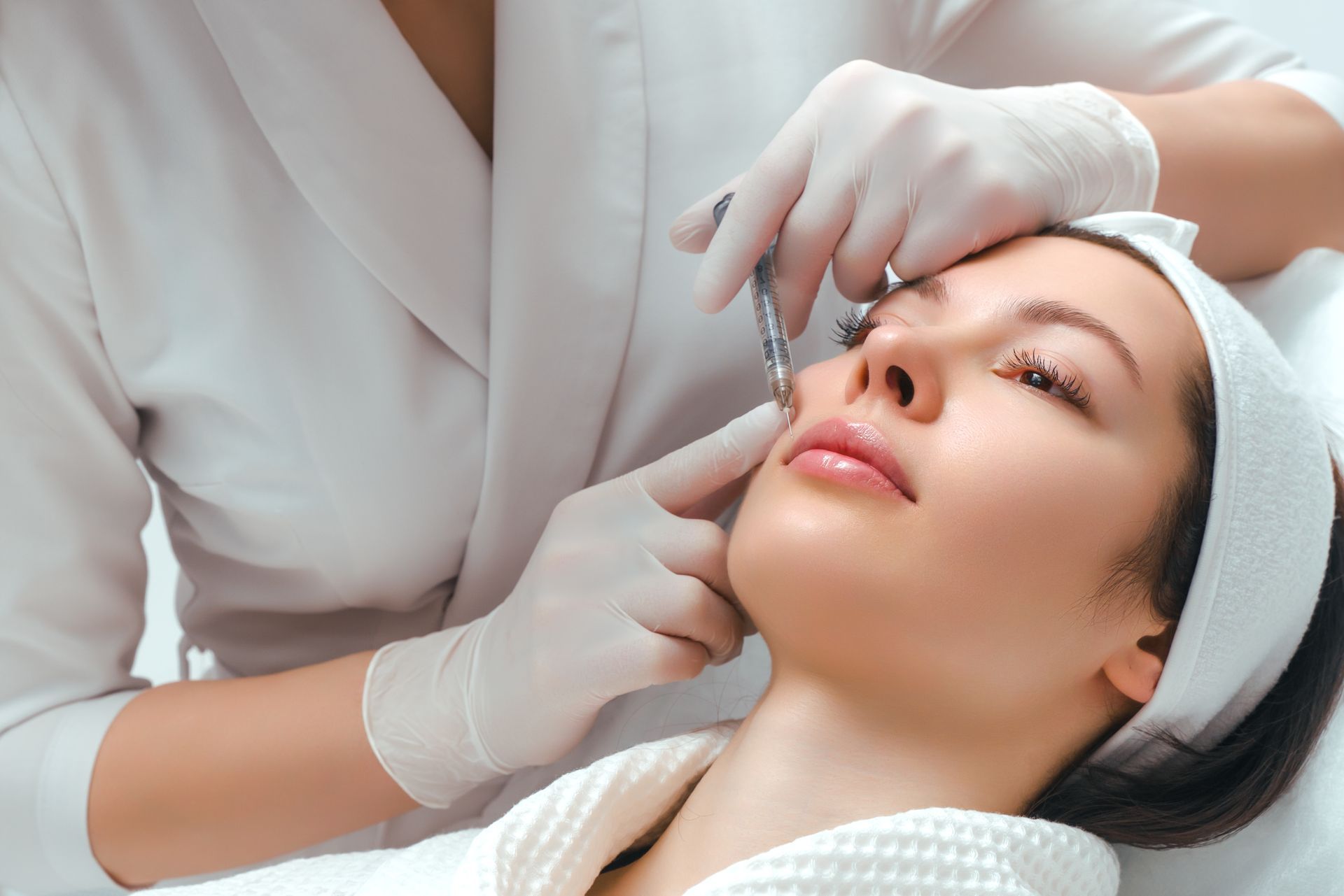 A woman is getting a facial treatment at a beauty salon.