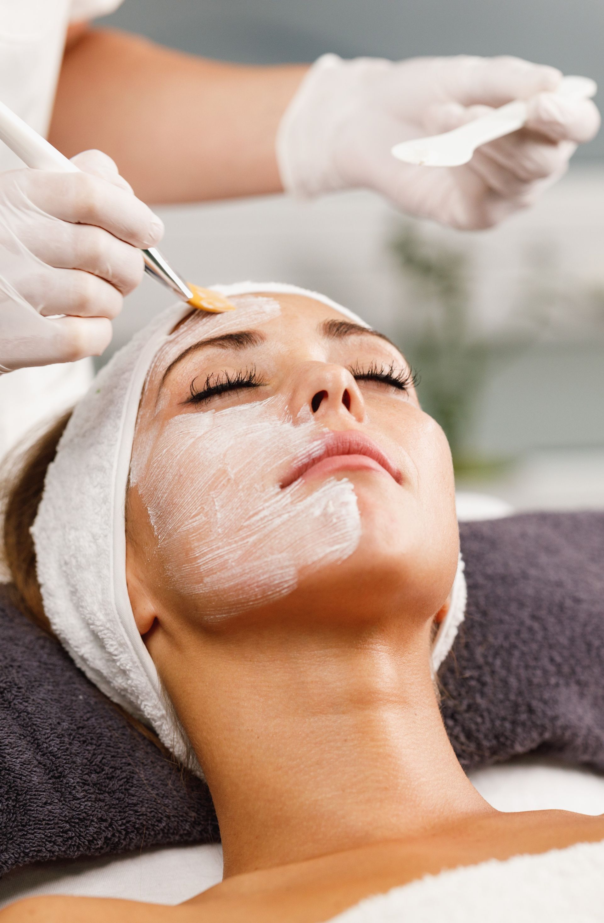 A woman is getting a facial treatment at a spa.