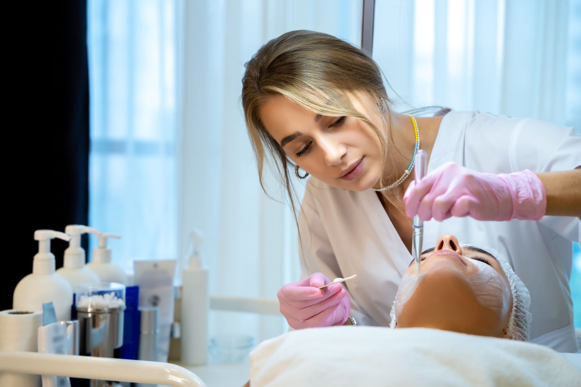 A woman is getting a hydrafacial treatment on her face.