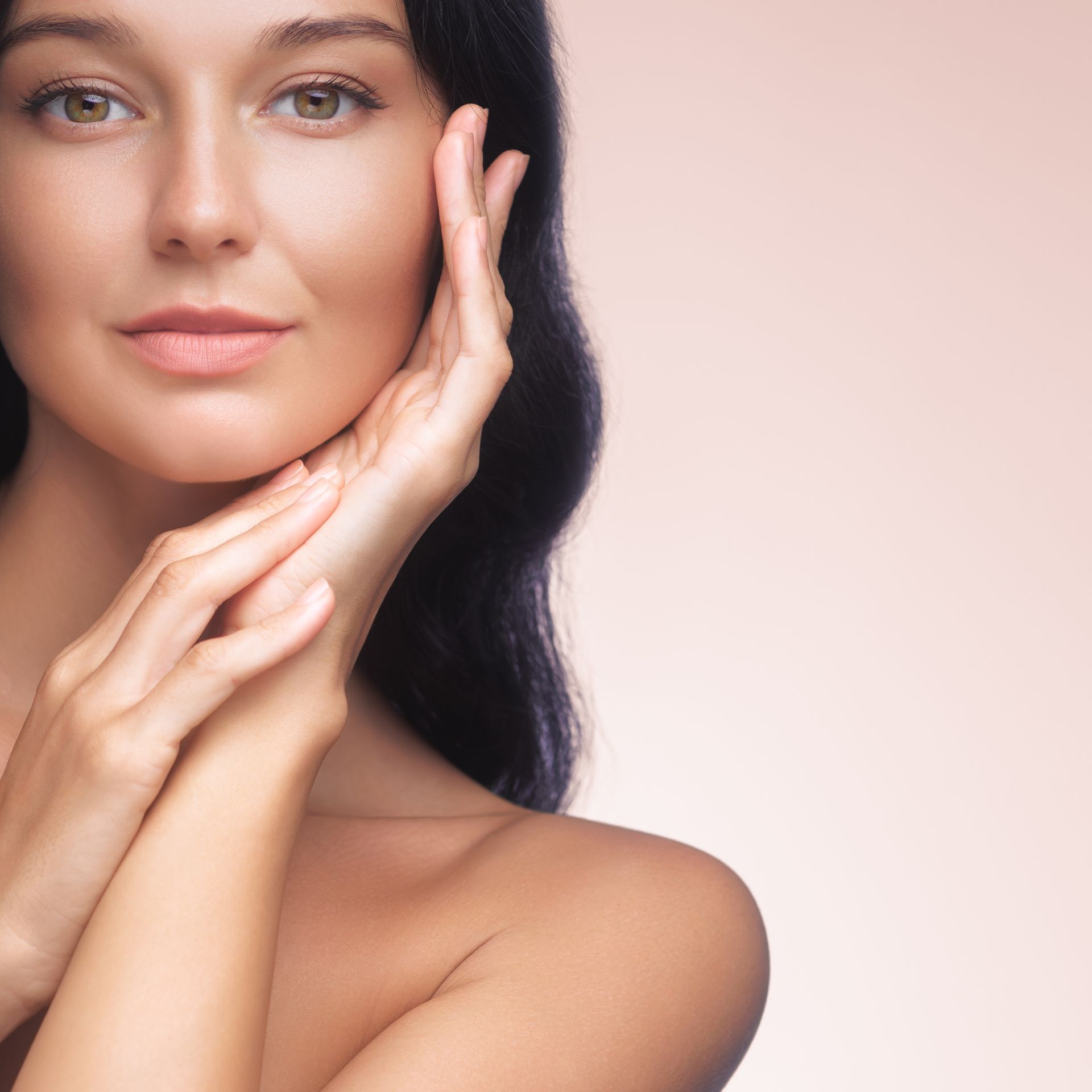 A close up of a woman 's face with her hands on her face