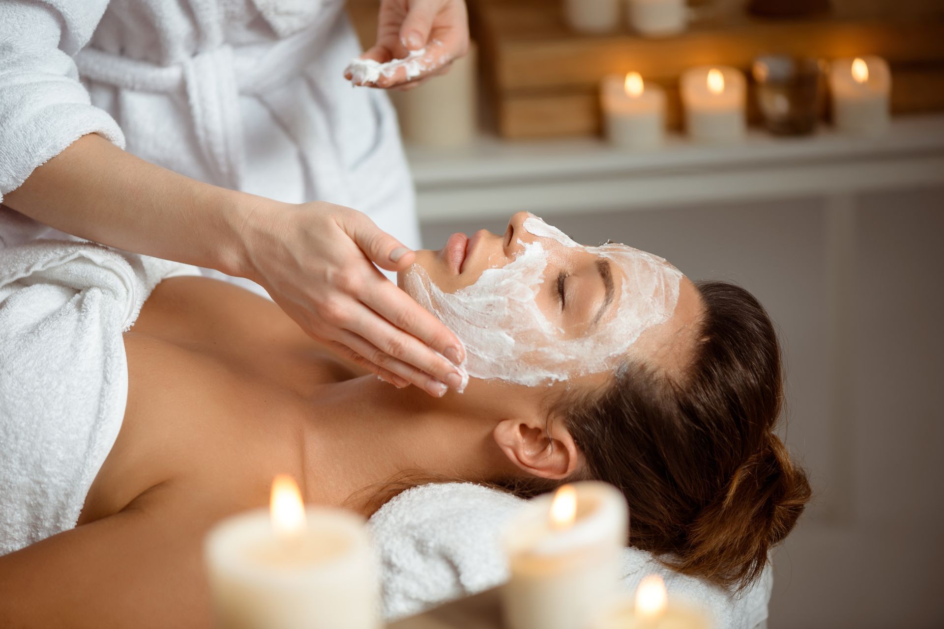 A woman is getting a facial treatment at a spa.