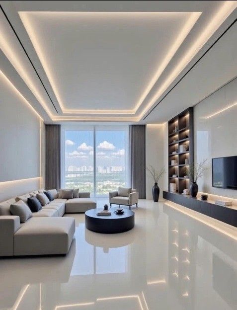 Modern living room with neutral colors, large windows, and built-in shelving and lighting.