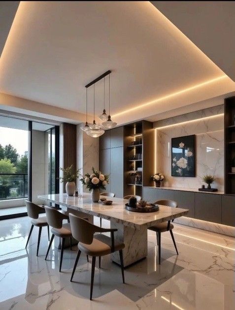 Elegant dining room with marble table, tan chairs, and built-in shelving with ambient lighting.