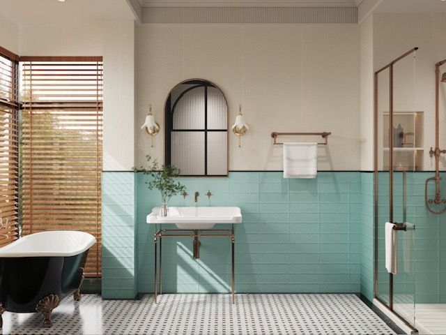 Bathroom with a black clawfoot tub, teal tile, white sink, and arched mirror.