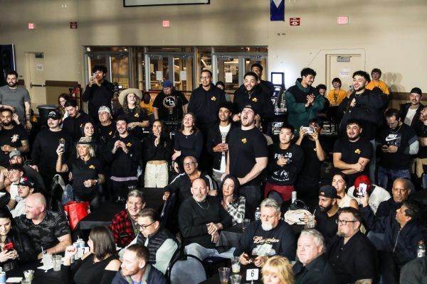 A large group of people are sitting at tables in a room.