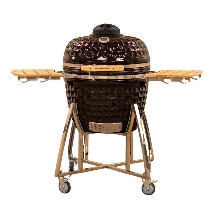 Brown ceramic kamado-style grill on a tan wheeled stand with wooden side shelves