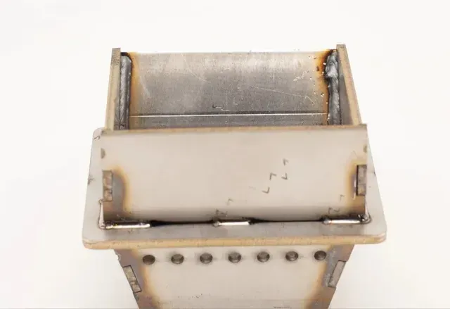 Close-up of a metal mechanical part with a white casing and rusted edges