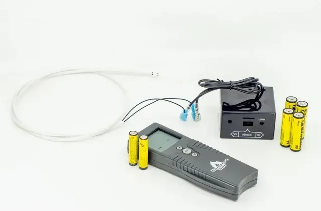 Thermal camera kit with handheld display, probe, cables, and yellow batteries on a white background