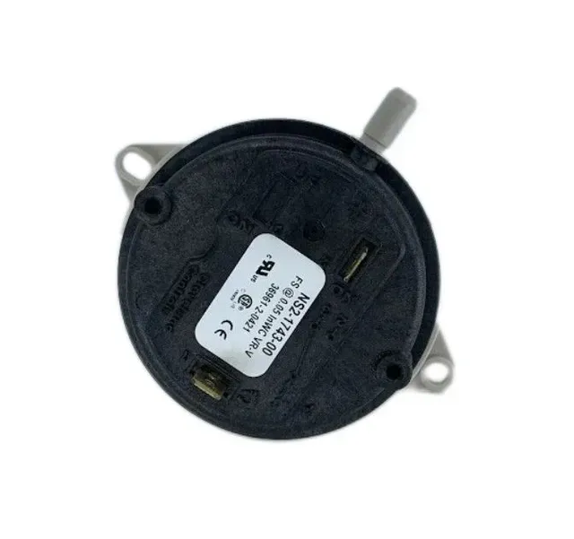 Black round electronic component with mounting tabs and a white label on a white background