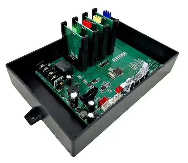 Open black electronic enclosure with green circuit board and upright colored modules inside