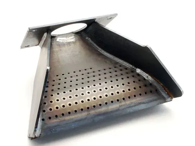 Metal perforated stove/oven burner insert with a white mounting flange and dark side panel
