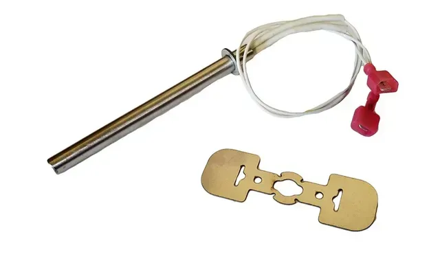 Metal ignition key with a clear cable loop and red tags beside a brass-style key blank
