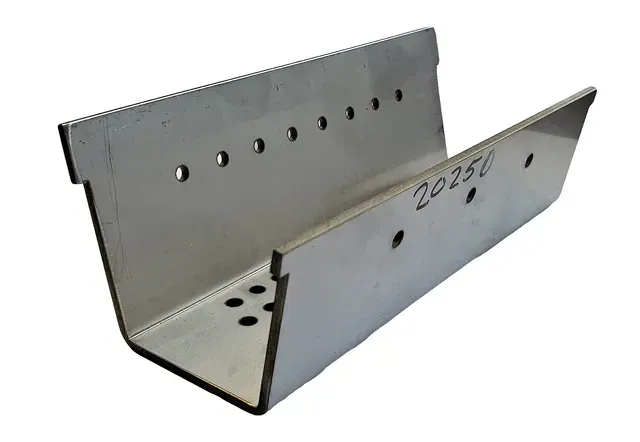Metal U-shaped bracket with rows of drilled holes on a white background