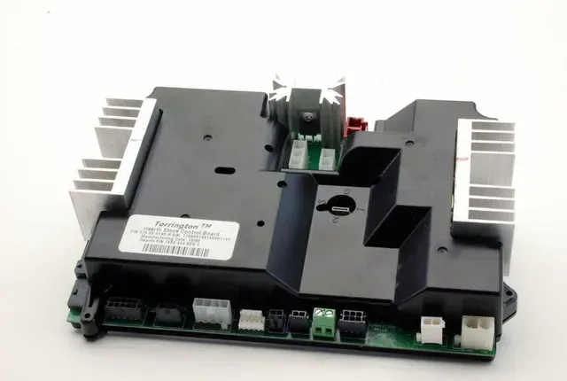 Black electronic circuit board with silver heatsinks and connectors on a white background