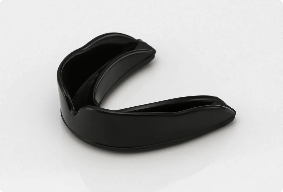 Black mouth guard is on a white counter