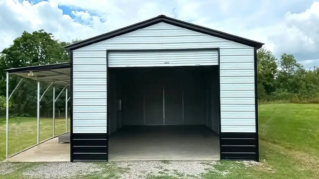 Metal garage with open door, black trim, and attached carport under a cloudy sky.