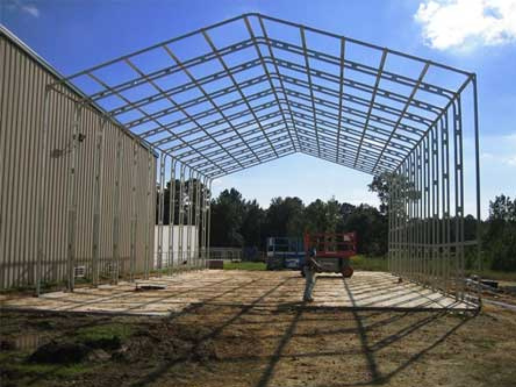 Metal frame of a building under construction. Metal framework against a blue sky.