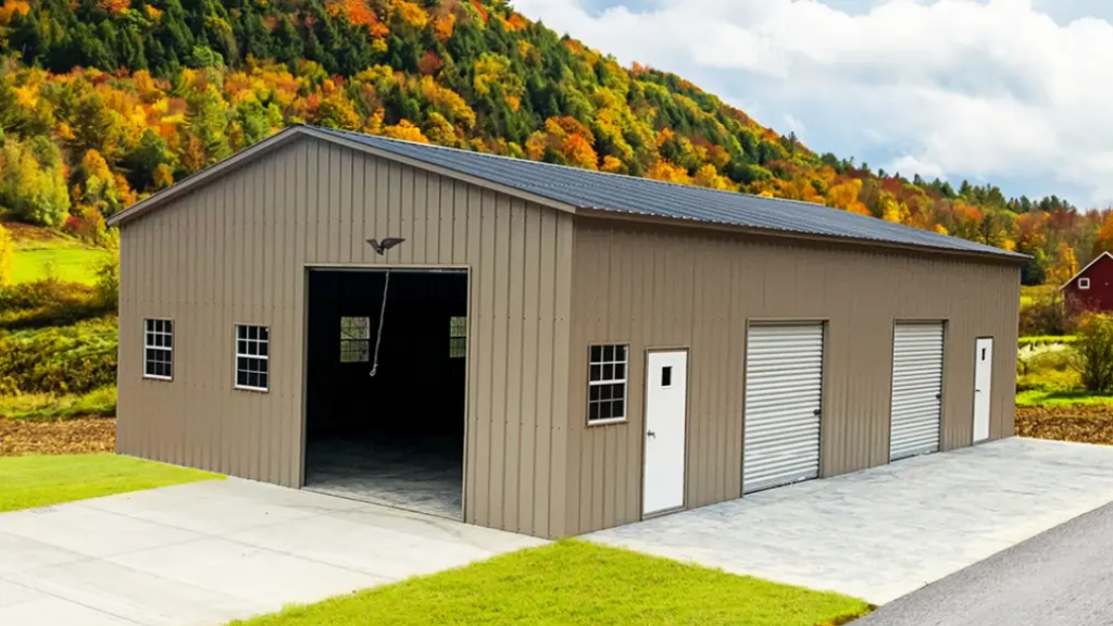 White barn with a red corrugated metal roof and open doors on a grassy lot.