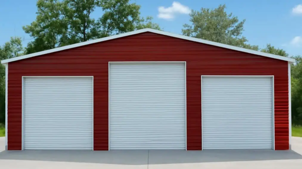 Red metal garage with three bays, set against a mountain backdrop.