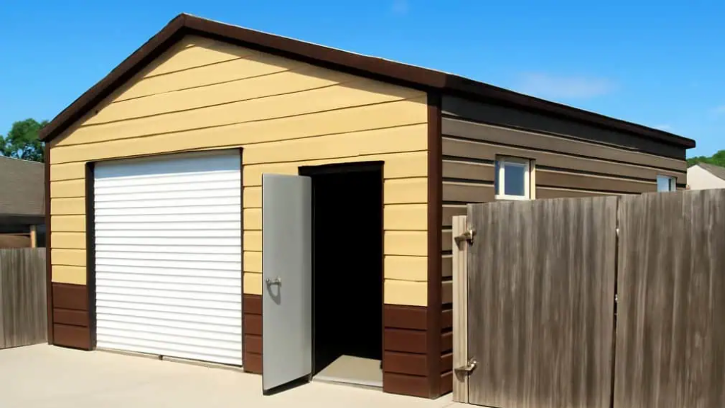 Two-car garage with red and white siding, red trim, and a concrete slab, set in a grassy area.